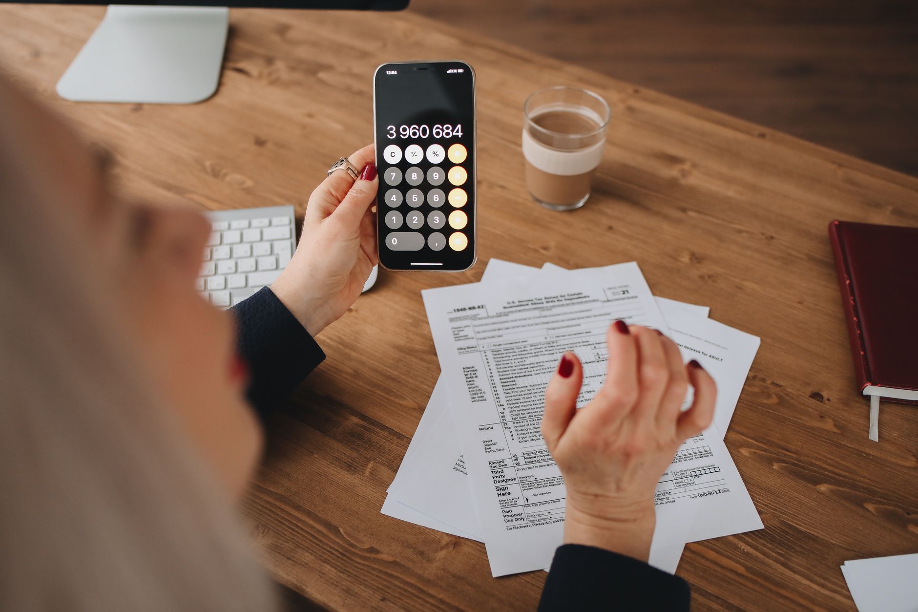 Persona calculando retenciones anuales con calculadora para preparar el Modelo 190