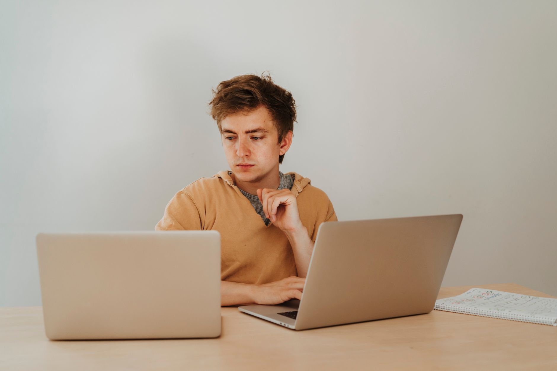 Persona trabajando en portátil en una oficina, compaginando su empleo con su actividad de autónomo